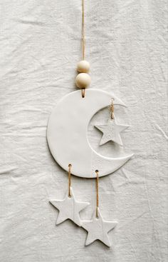 a white ornament with stars hanging from it's side