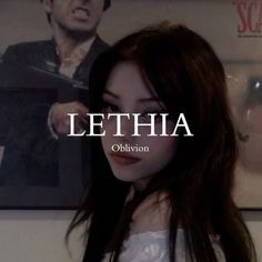 a woman with long hair standing in front of a poster that says lethia obrion