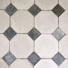 a white and grey tiled floor with black dots