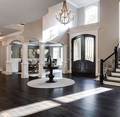 a large open floor plan with stairs leading up to the front door and entryway