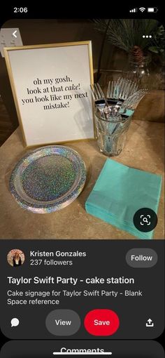 a table topped with a cake plate next to a sign