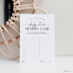 a memory game sitting on top of a table next to a wooden chair and plant