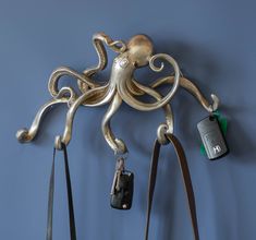 an octopus is hanging on the wall next to purses