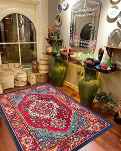 a room filled with vases and rugs on the floor