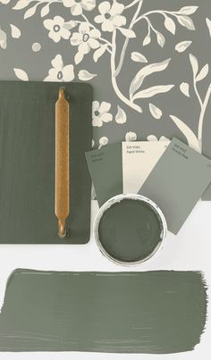 the paint is green and has white flowers on it, along with some other items