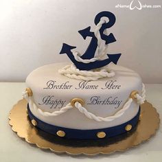 a white and blue cake with an anchor on top