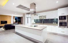 a modern kitchen with white cabinets and stainless steel appliances