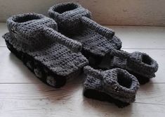 several pairs of crocheted shoes sitting on top of a wooden floor