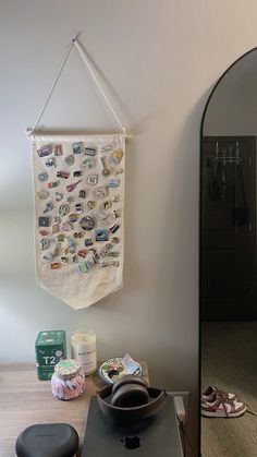 a wall hanging over a stove top oven with magnets on it's side