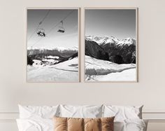 two black and white pictures hanging on the wall above a bed in front of a chairlift