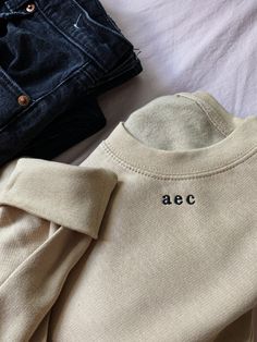 Placed thoughtfully along the right side of the collar, you (or the lucky recipient) will love the modest and classic serif initials on this comfy, crewneck sweatshirt. *Pictured is sand sweatshirt with black thread ** Please note this is for initials only and processing time is 1-2 weeks + shipping (1-5 days) Features ○ 80/20 Cotton & Polyester ○ Unisex Sizing ○ Eco Shipping Thanks a bunch for shopping small 💛 Crewneck Design Ideas, Bridesmaid Sweatshirts, Initial Sweatshirt, Comfy Crewneck, Simple Sweatshirt, Monogram Sweatshirt, Embroidered Initials, Wedding Party Gifts, Gifts Bridesmaid