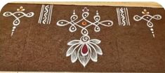 a brown rug with white and red designs on it