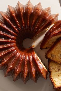 a bundt cake on a plate with slices cut out