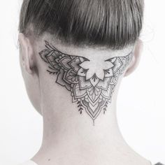 a woman's neck with a tattoo design on it