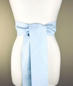 Wide Textured Icelandic Blue Sash  Pastel Blue Dupioni Sash  Light Blue Dress Sash  Dupioni Belt, Baby Blue  Wedding Dress Sash  Add sophistication and rich texture to your special occasion outfit with this Satin Swank® dupioni waist sash. Depending on your waist size and the length you choose (75 and 90 inch lengths available), you can wrap this sash around your waist once or twice. You decide whether to tie the sash in a bow or a simple knot with long-hanging tails. Tie in front, in back, or on the side. A double layer of dupioni fabric in Icelandic Blue. Sash is the same front and back, seams are hidden within the fold lines, and ends are finished on the angle. Dupioni features a rustic weave with naturally occurring slubs and tiny thread loops running throughout the fabric resulting in Baby Blue Wedding Dress, Baby Blue Wedding Dresses, Baby Blue Wedding, Blue Sash, Baby Blue Weddings, Blue Wedding Dress, Occasion Outfit, Wedding Dress Sash, Light Blue Dress