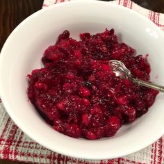 a white bowl filled with cranberry sauce on top of a table