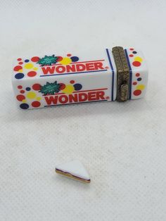 an empty wonder candy bar sitting on top of a table next to a small white object