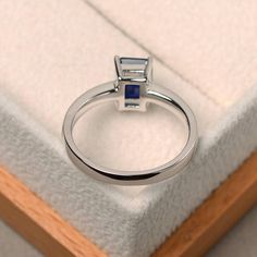 Unique wedding ring blue sapphire ring emerald cut blue | Etsy Blue Emerald Cut Ring With Bezel Setting, Blue Emerald Cut Rings With Bezel Setting, Modern Blue Radiant Cut Rings, White Gold Sapphire Promise Ring Square Cut, White Gold Square Cut Sapphire Promise Ring, Square Cut Sapphire Ring In White Gold For Promise, Blue Topaz Emerald Cut Ring With Bezel Setting, Emerald Cut Sapphire Solitaire Promise Ring, Emerald Cut Solitaire Sapphire Promise Ring