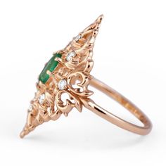 Feel free to contact us to make a custom order inquiry. Emerald Ring with diamonds is a beautiful creation in Yellow Gold embellished with classical ornamental leaves design, accented with Natural Zambian Faceted Emerald and White Diamonds. Materials: 14K Yellow Gold, 0.5ct Natural Faceted Emerald, 8 White Natural Diamonds totaling .24cts. Available in 14K and 18K Yellow Gold Luxury Green Emerald Ring With Rose Cut Diamonds, Art Deco Green Emerald Ring With Rose Cut Diamonds, Art Deco Emerald Ring With Rose Cut Diamonds, Fine Jewelry Emerald Ring With Intricate Design, Fine Jewelry Yellow Gold Emerald Ring With Intricate Design, Art Deco Emerald Jewelry With Rose Cut Diamonds, Ceremonial Diamond Gemstone Rings, Elegant Yellow Gold Emerald Ring With Intricate Design, Exquisite Green Emerald Ring