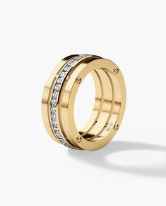 a gold ring with three rows of diamonds on the inside and outside, set against a white background