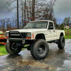 a white truck parked on top of a parking lot