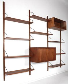 a wooden shelf with three shelves and two shelving units on each side, against a white background