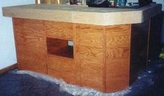 a kitchen counter with water coming out of the floor and on top of it's cabinets