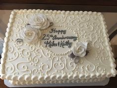 a 25th wedding anniversary cake decorated with white roses