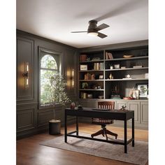 a home office with built - in bookcases and a ceiling fan is shown