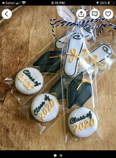 graduation cookies are wrapped in cellophane on a wooden table