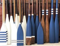 a row of wooden paddles lined up next to each other in front of a wall