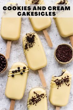 several popsicles with chocolate sprinkles and toppings on wooden spoons