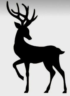 the silhouette of a deer with antlers on it's back