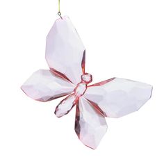 an ornament shaped like a flower hanging from a string on a white background