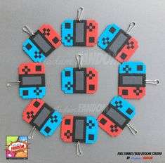 a set of six lego style earrings made to look like video game controllers with red, blue and black squares on them