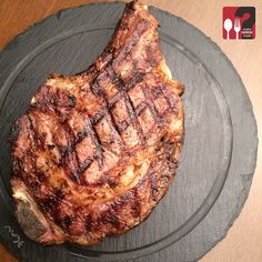 a piece of meat sitting on top of a black plate