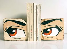 two bookends with eyes painted on them