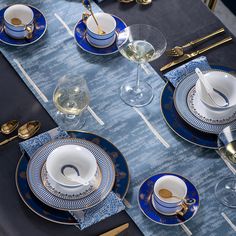 the table is set with blue and white dishes