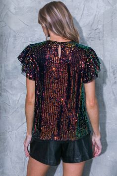 This GET THE LOOK WOVEN TOP is the perfect statement piece for any occasion. Crafted from sequins, it features a round neckline, short sleeves, and a convenient back neck button closure. Show off your beautiful style and look your best. DetailsSelf : 97% Polyester 3% SpandexContrast : 100% PolyesterLining : 100% Polyester Size & Fit- Model is 5`8" And Wearing Size Small- Measurements Taken From Size Small- Approx. Length: 24" Tulle Tops, Black Sequin Top, Maxi Tops, Ruffle Sleeve Blouse, Flying Tomato, Beautiful Style, Woven Top, Ruffle Sleeves, Look Your Best