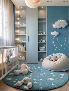 a baby's room decorated in blue and white with stars on the rugs