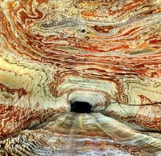 the inside of a cave that looks like it has been painted red and yellow