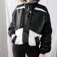 80s/90s retro windbreaker jacket has cool black and white colorblocked panels. Fabric feels like a classic windbreaker nylon material with a heathered cotton lining inside, jacket feels overall medium-weight. Has a funnel neck with striped trim detail throughout. I love the white triangle detail on the back of the jacket.  Piece is in very good to excellent condition - there are some very light gray discolored blotches on the front white pocket panels, photo is included, I'm guessing this is a l White Windbreaker With Contrast Color For Fall, Retro Black Outerwear With Contrast Color, White Contrast Color Windbreaker For Fall, Black Color Block Windbreaker For Winter, Black Winter Windbreaker With Color Block, Black Nylon Color Block Outerwear, Black Color Block Nylon Outerwear, White Windbreaker With Contrast Color For Outdoor, Retro Black Color Block Outerwear