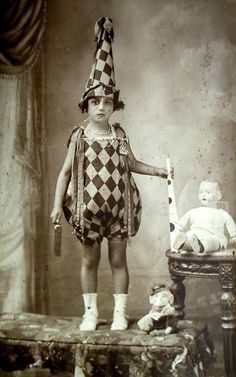 an old photo of a child dressed as a clown