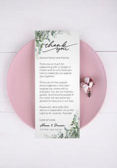 a pink plate with a thank note on it and flowers in the middle, along with a white background