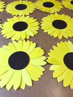 paper sunflowers are laid out on the floor