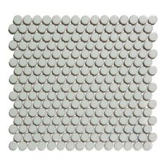 a white tile with lots of circles on the top and bottom, all in different sizes