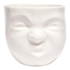 a close up of a white cup with a face on it