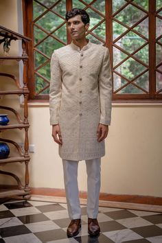 Beige sherwani with thread, sequin, bead embroidery in scallop pattern. Paired with pant. - Aza Fashions Fitted Raw Silk Sherwani With Naqshi Details, Fitted Raw Silk Sherwani With Naqshi, Fitted Sherwani With Intricate Embroidery And Traditional Drape, Fitted Sherwani With Intricate Embroidery In Traditional Drape, Fitted Long Embroidered Bandhgala, Traditional Fitted Raw Silk Sherwani, Fitted Sherwani With Intricate Embroidery And Long Sleeves, Fitted Raw Silk Bandhgala With Intricate Embroidery, Fitted Long Sleeve Sherwani With Intricate Embroidery