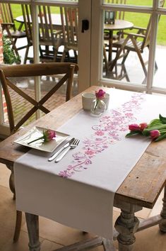 the table is set with flowers and silverware