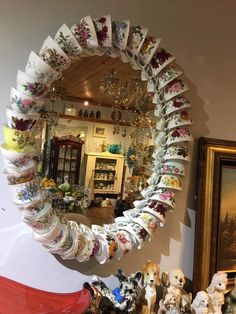 a mirror that is sitting on top of a shelf next to some figurines